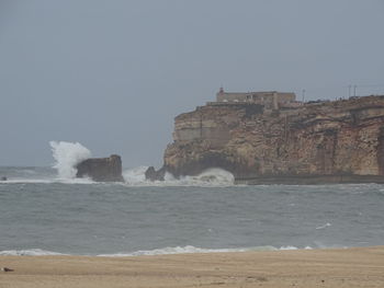 View of built structure by sea