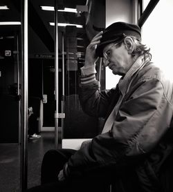 Side view of man sitting on train