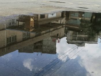 Reflection of buildings in puddle