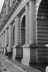 Rear view of man walking on building