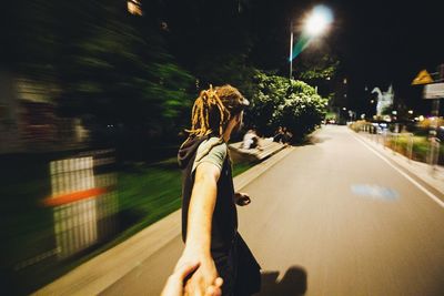 Woman on road in city at night