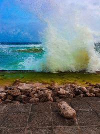 Scenic view of rocks on sea against sky