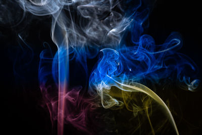 Concept of abstract smoke colored with the colors of russian and ukrainian flags