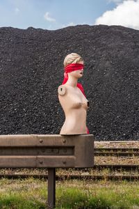 Close-up of mannequin against mountain