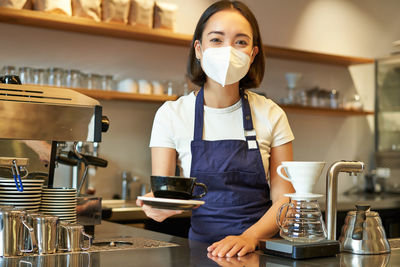 Midsection of woman drinking coffee