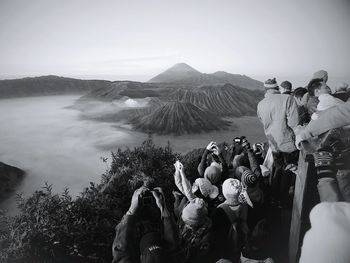 Scenic view of tourists photographing sights of bromo mountain