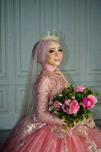 Portrait of bride holding flower bouquet