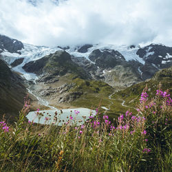 Scenic view of snow covered mountains against sky