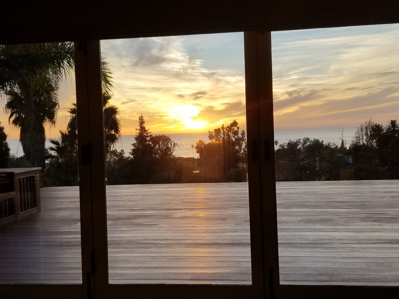 SCENIC VIEW OF SUNSET THROUGH WINDOW