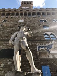 Low angle view of statue against building