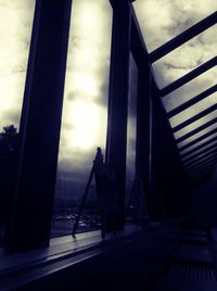 Low angle view of bridge against cloudy sky