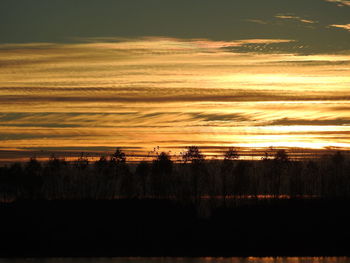 Scenic view of silhouette trees against sky during sunset