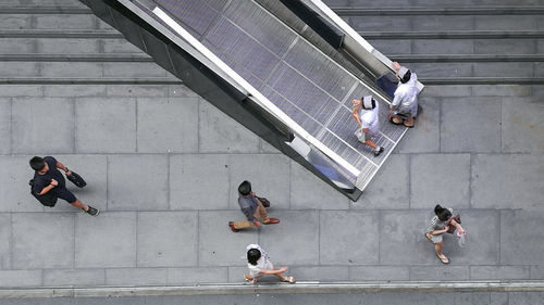 High angle view of people walking on staircase