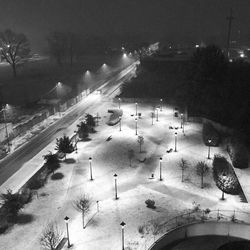 Crowd on road against sky at night