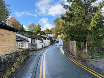 Haycliffe lane, with stone walls, small cottages, and old trees, on a cloudy day in, bradford, uk