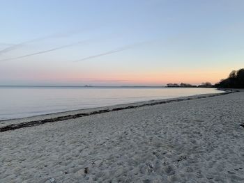 Scenic view of beach against sky during sunset