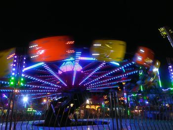 Low angle view of illuminated lights at night