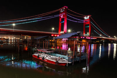 View of ampera bridge  over river at night