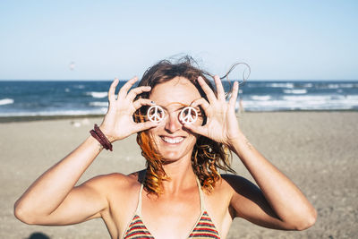 Portrait of woman wearing hat on beach