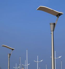 Low angle view of lamp post against clear blue sky