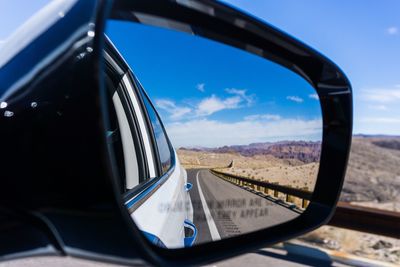 Close-up of side-view mirror of car