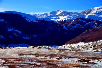 Scenic view of snowcapped mountains against sky