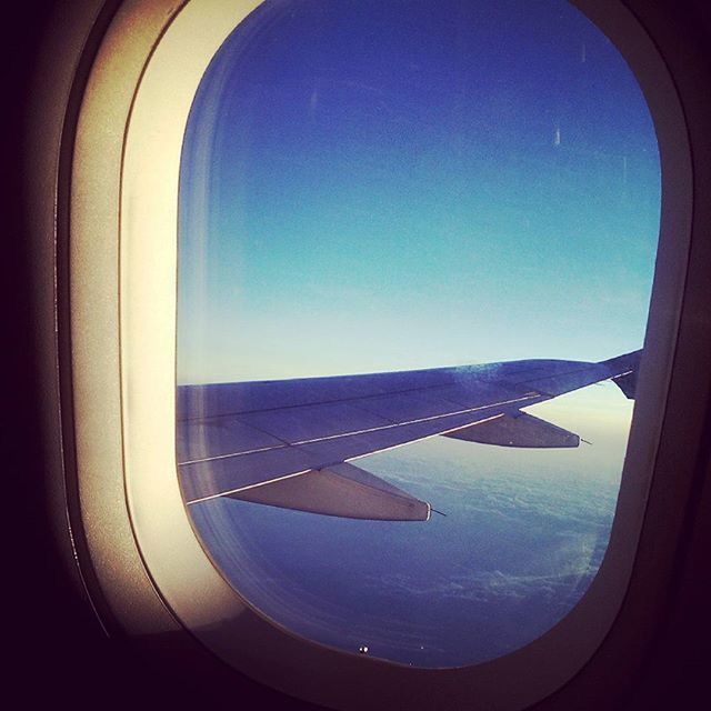 airplane, window, blue, air vehicle, flying, indoors, sky, transparent, transportation, glass - material, vehicle interior, mode of transport, mid-air, part of, aircraft wing, clear sky, copy space, cropped, no people, nature