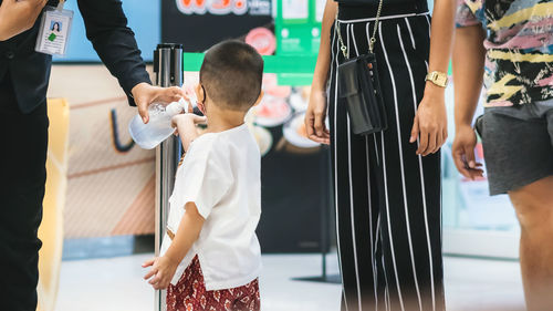 Rear view of people standing outdoors