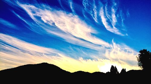 Low angle view of silhouette mountain against sky at sunset