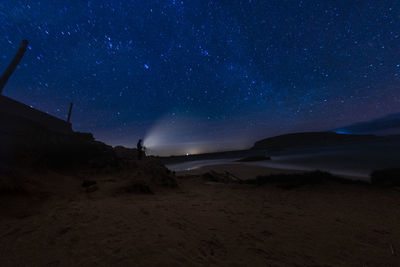 Scenic view of landscape against sky at night