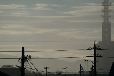 Low angle view of electricity pylon against sky