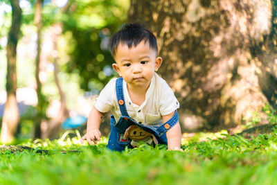 Portrait of cute boy playing in grass