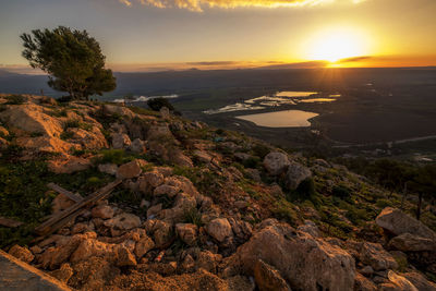 Scenic view of rocks against sky during sunset