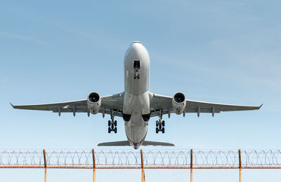 Airplane flying against clear blue sky