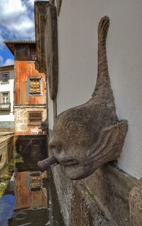 Close-up of statue against built structure