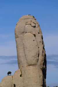 Low angle view of rock formation against sky