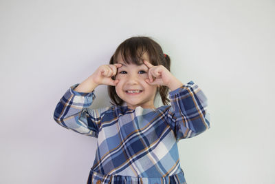 Portrait of smiling boy against white background