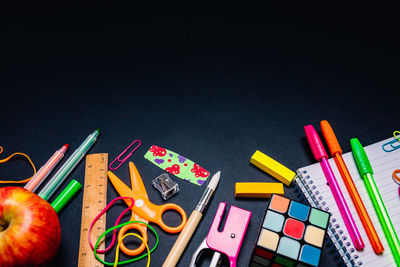 High angle view of multi colored pencils on table against black background