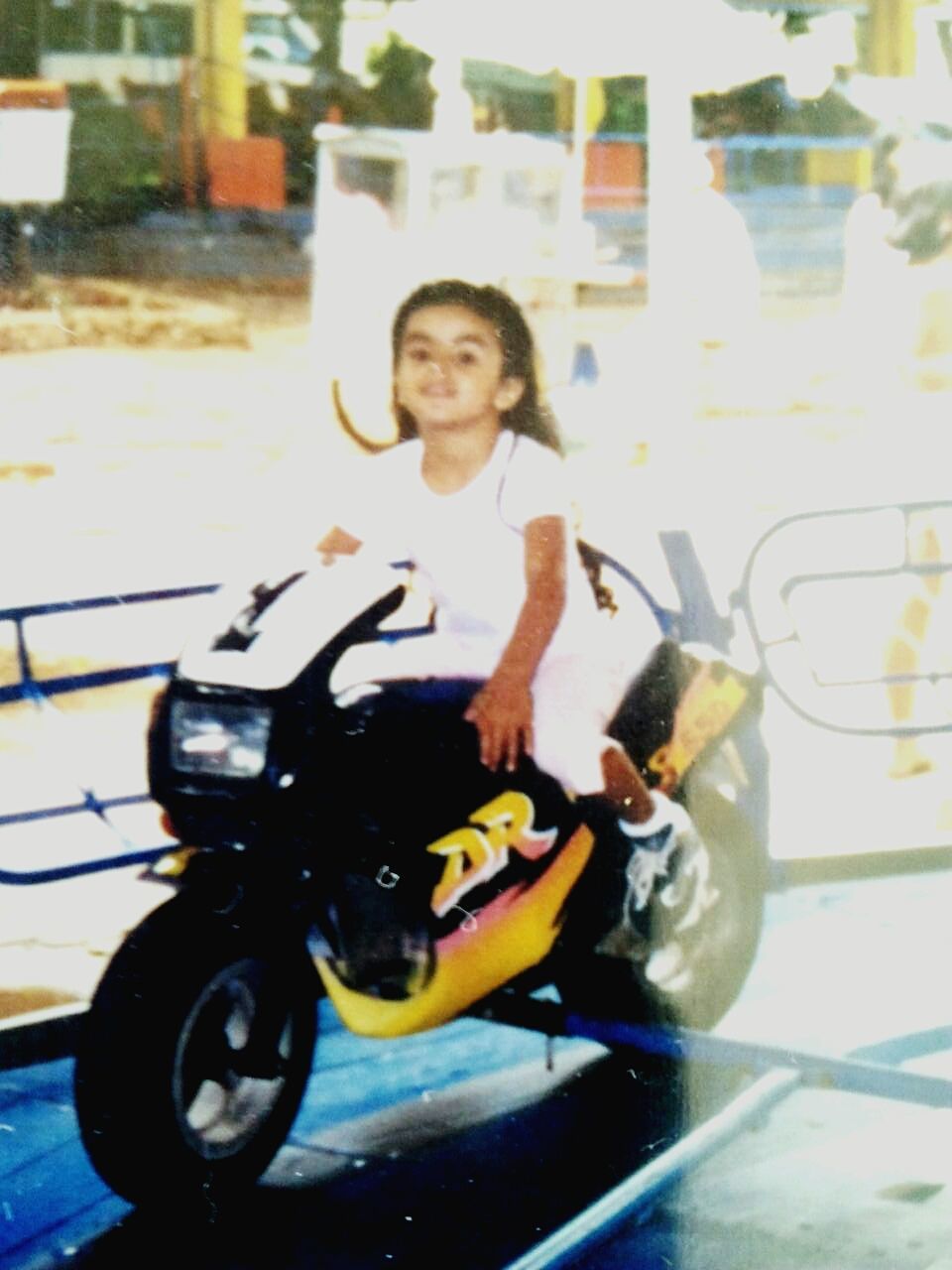 land vehicle, lifestyles, looking at camera, full length, transportation, mode of transport, portrait, leisure activity, person, casual clothing, front view, childhood, sitting, holding, car, street, bicycle, elementary age