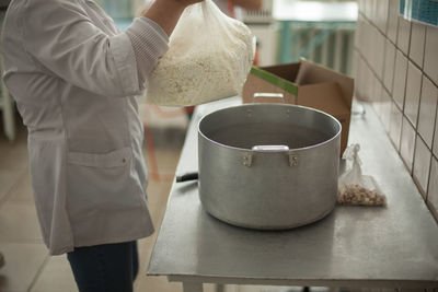 Midsection of man preparing food in kitchen