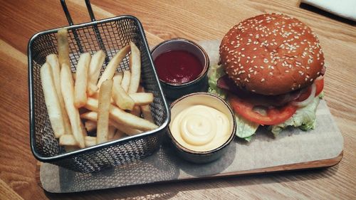 Close-up of burger and vegetables on table