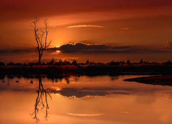 Scenic view of lake against romantic sky at sunset