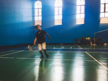 Full length of boy playing badminton