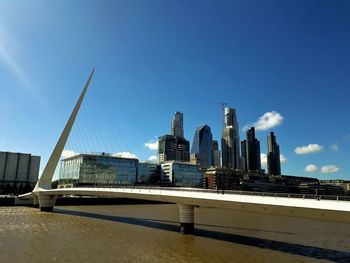 Low angle view of skyscrapers against blue sky