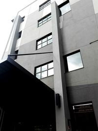 Low angle view of office building against sky