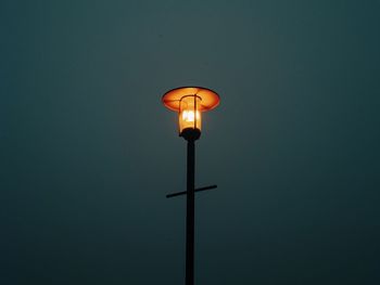 Low angle view of illuminated lantern against clear sky at night