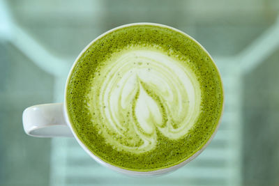 Close-up of green tea cup on table