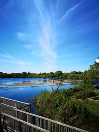 Scenic view of lake against blue sky