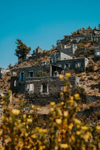 Low angle view of old building against clear blue sky