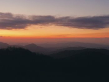 Scenic view of silhouette mountains against sky during sunset